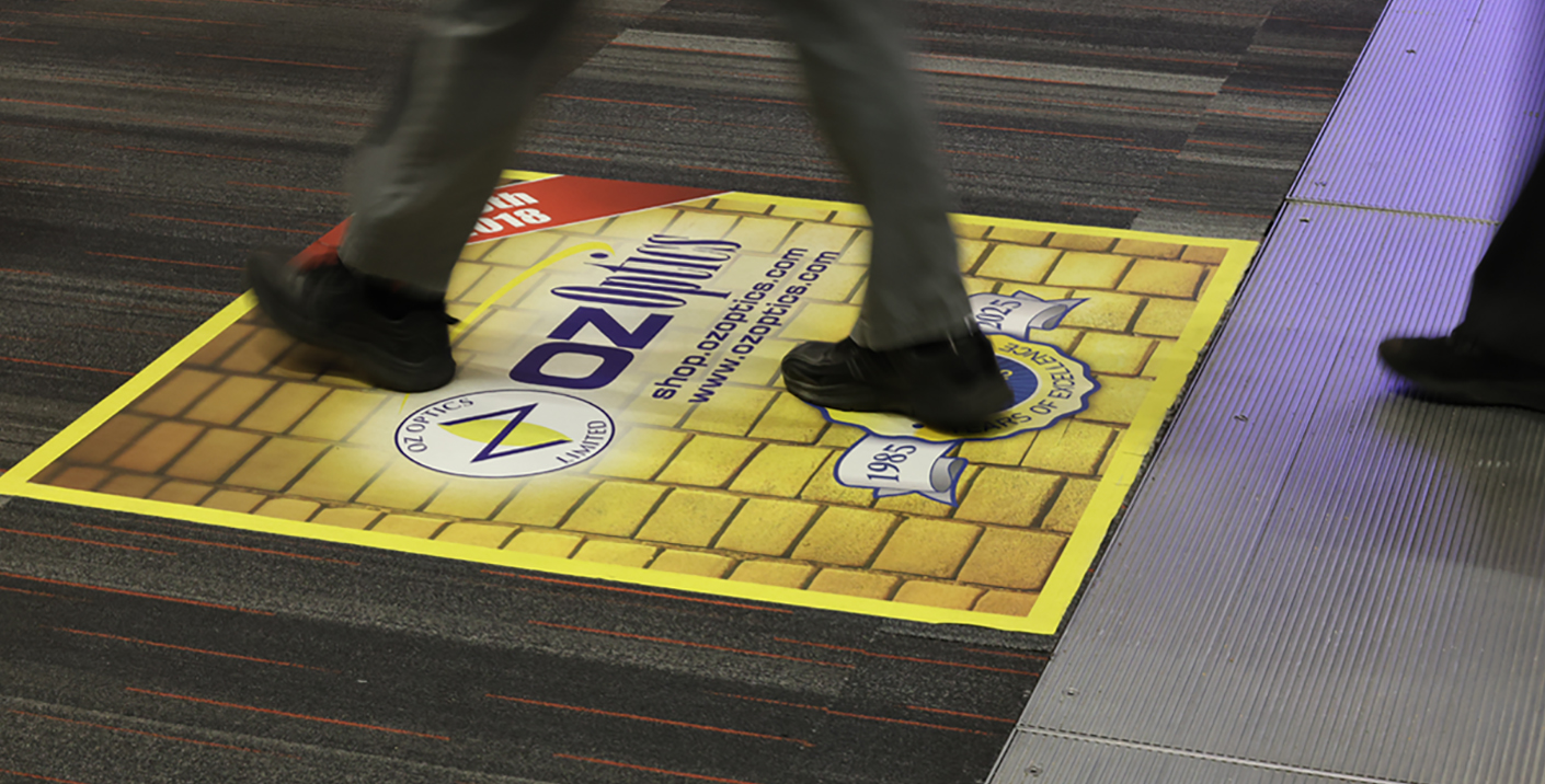 person walking over a floor advertisement