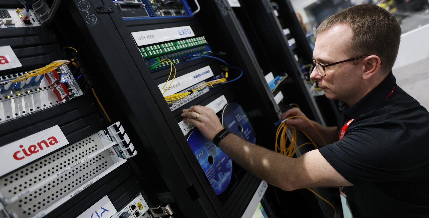 Person changing connections in a server rack